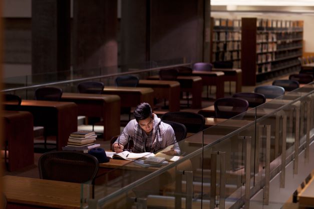 male-student-alone-in-library
